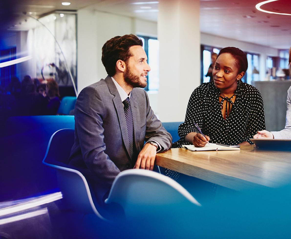 A man and two women having a discussion