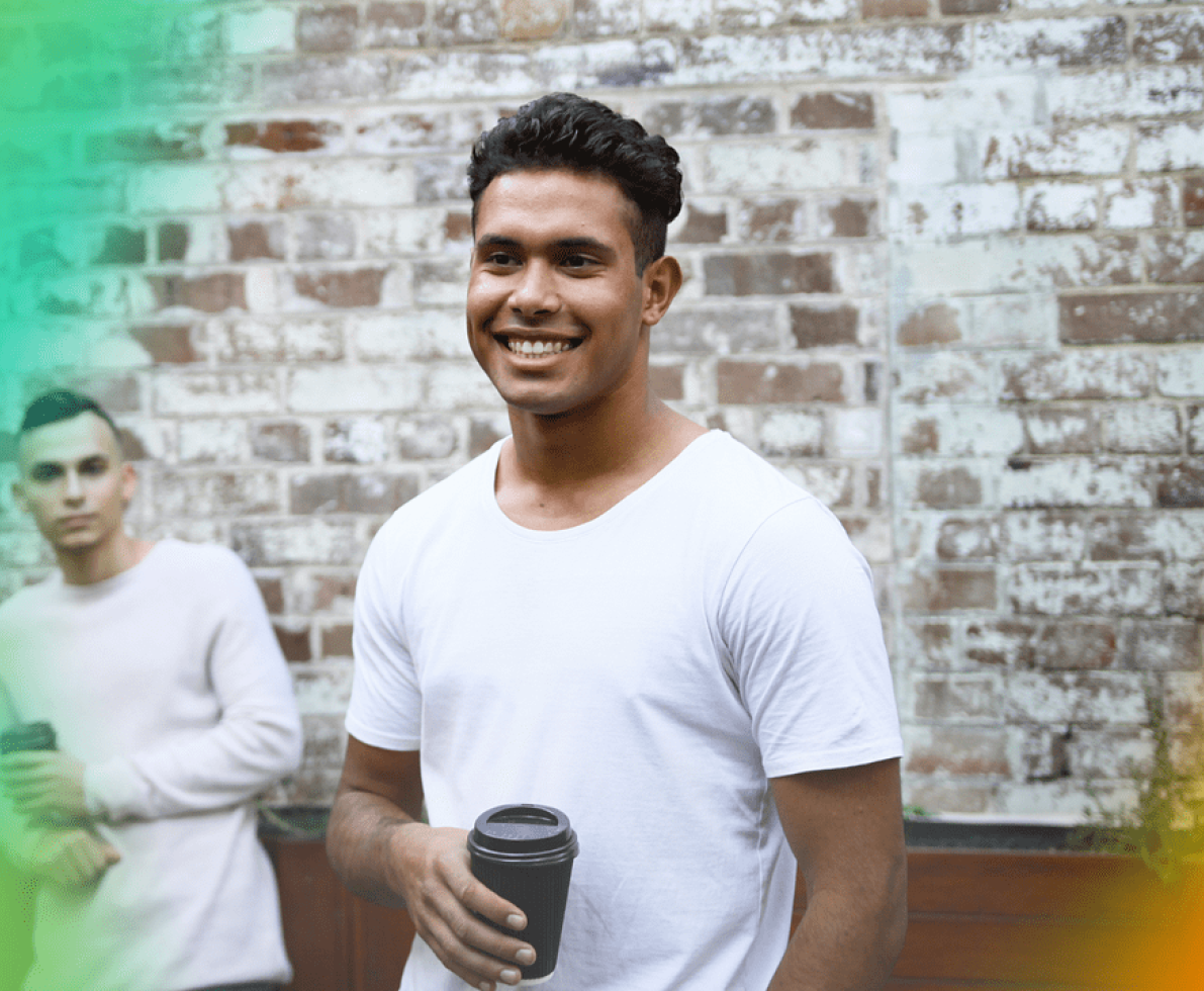 A photo of a man holding a cup of coffee