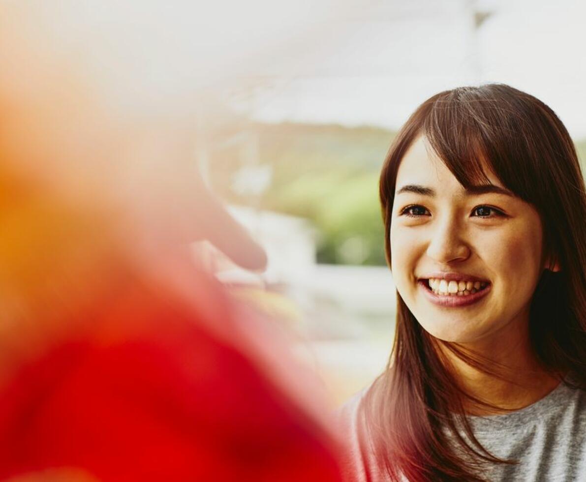 A smiling woman looking to the left