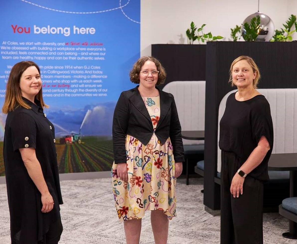 3 women standing smiling 