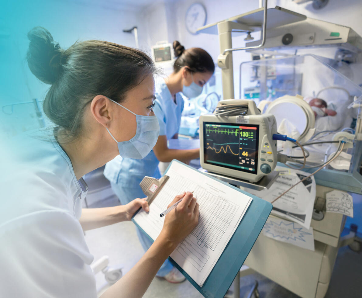 neonatal nurse (NICU) smiling with a mask on, doing work 