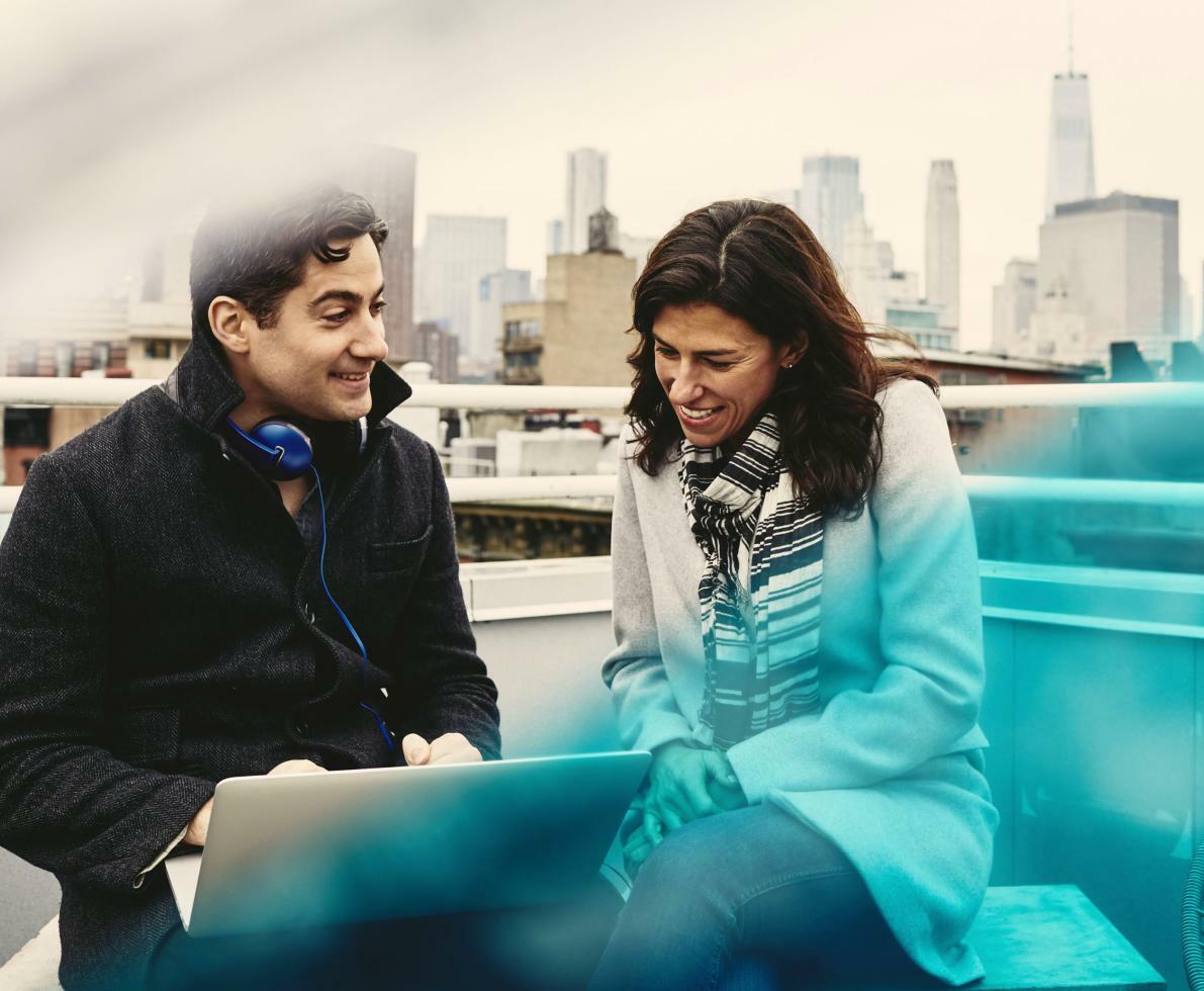 Man and woman on a rooftop talking