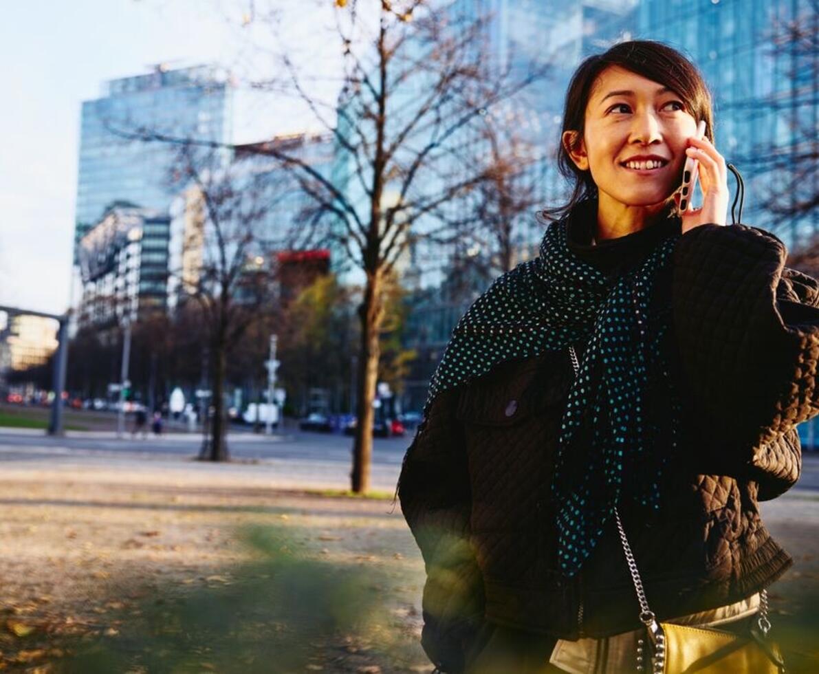 woman on the phone smiling in nature