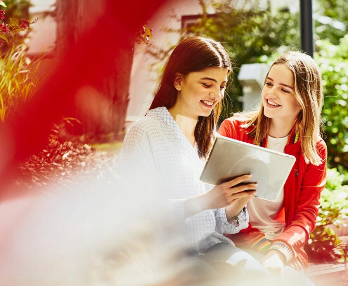 Young women looking at a tablet smiling