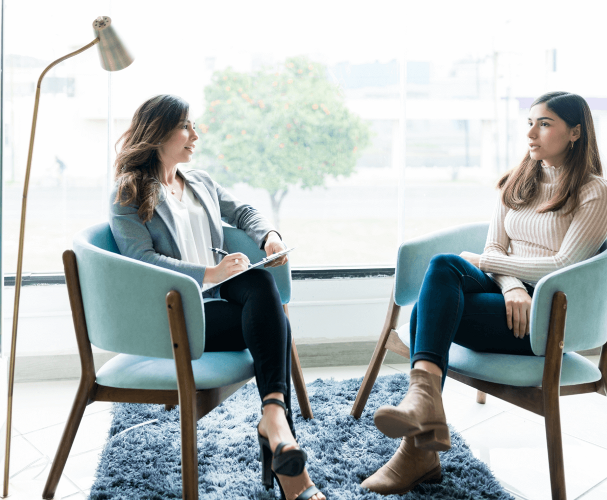 A woman getting interviewed by another while seated 