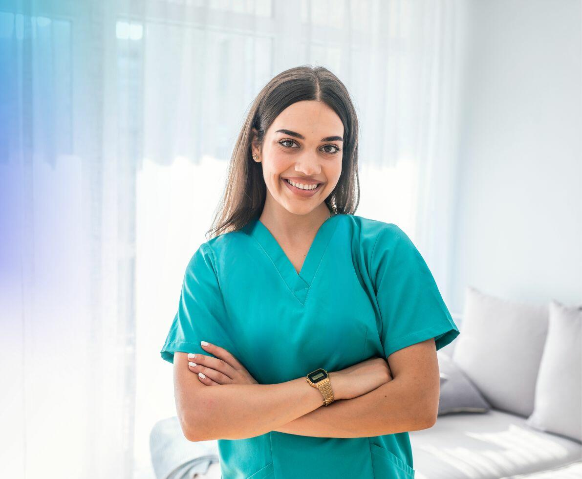 an image of a female nurse smiling with her arms crossed