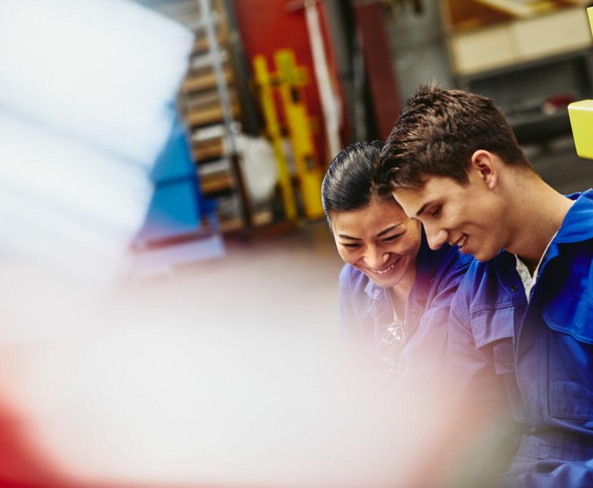 Male and female operator working together while smiling