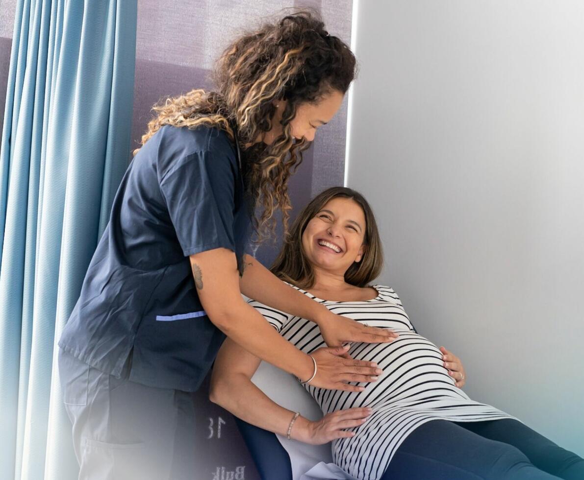 healthcare professional examining a pregnant patient