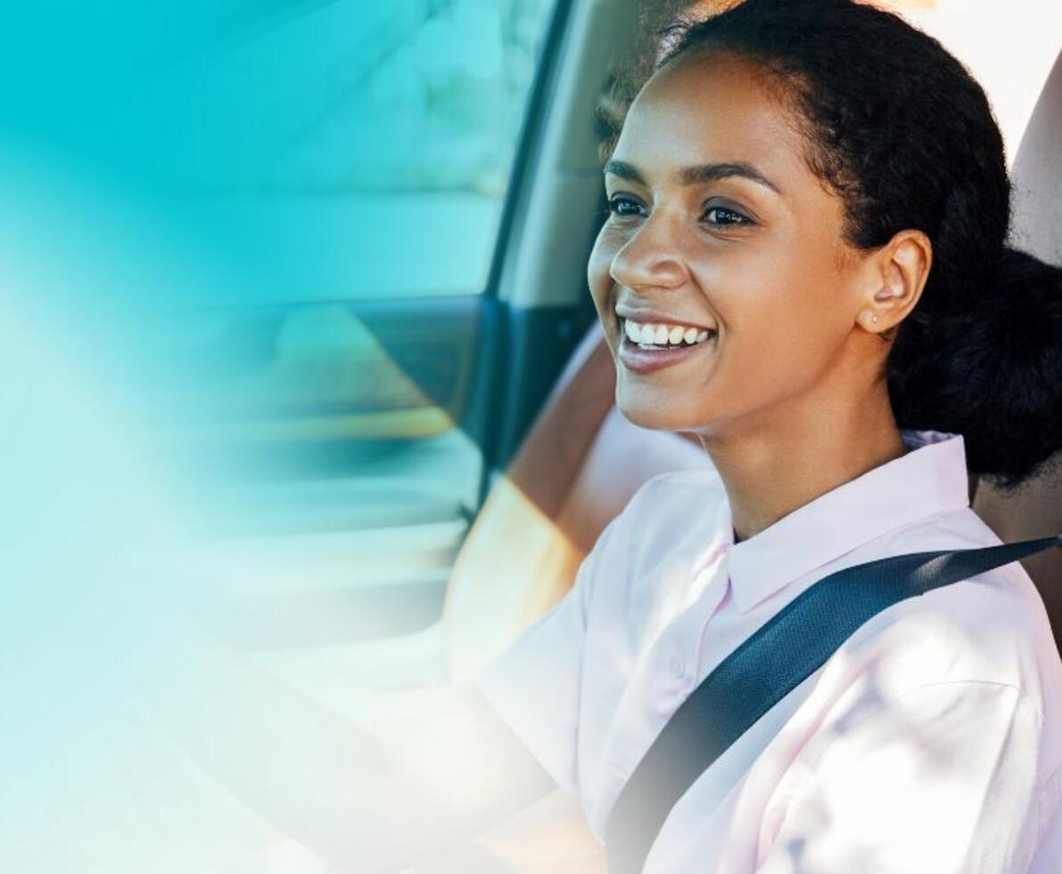 woman smiling driving a car