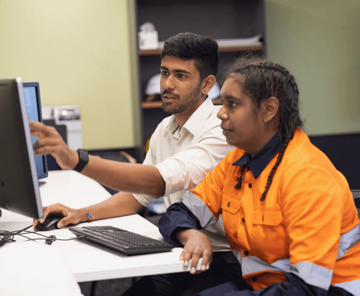 an image of mining workers looking at a monitor