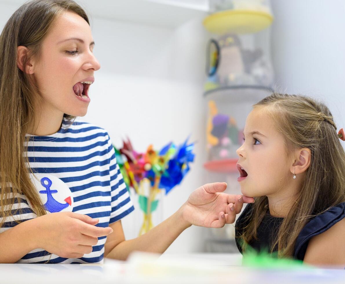 image of a speech pathologist with her young patient image of a speech pathologist with her young patient