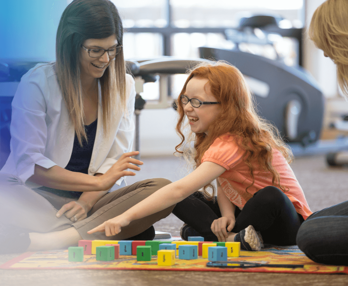 an image of a woman playing with blocks with a child 