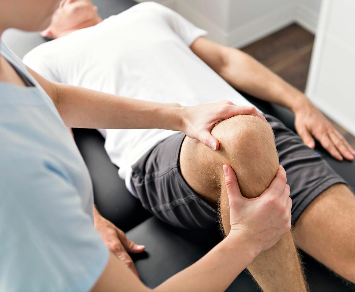 image of an occupational therapist working on his patients knee