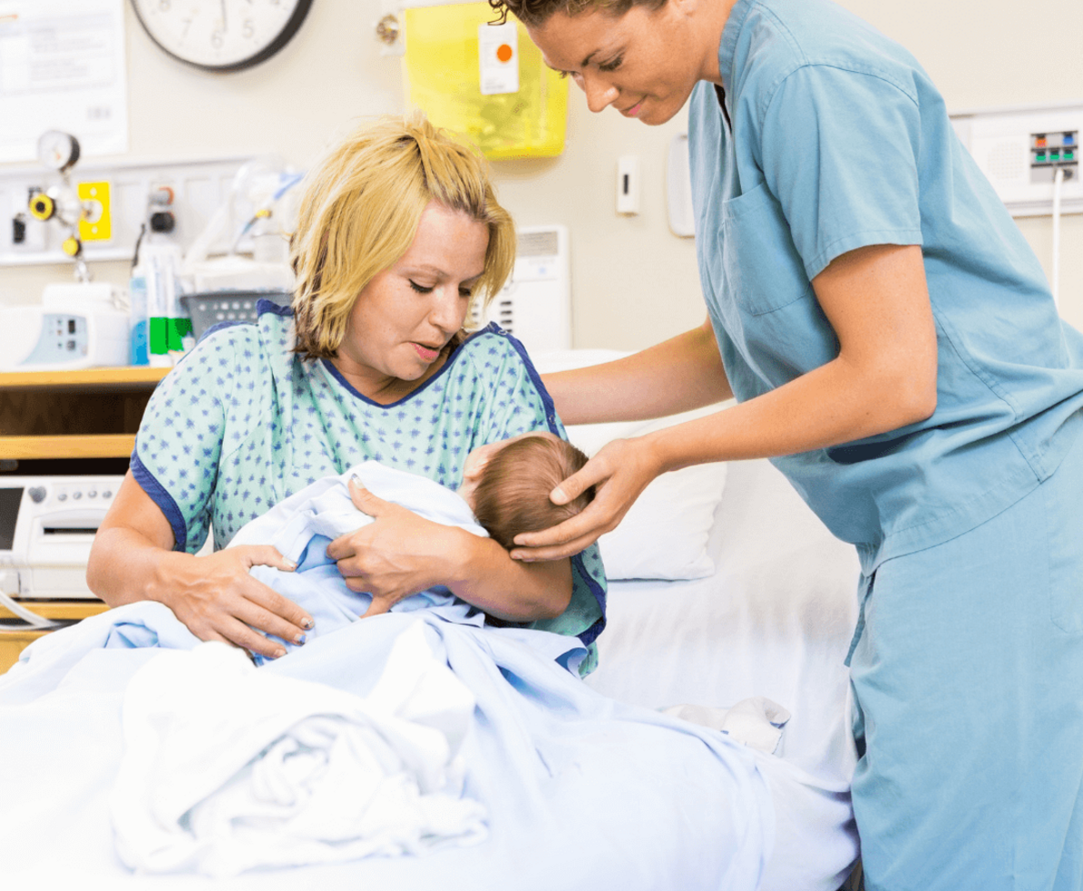 an image of a woman holding her baby with a nurse supporting her