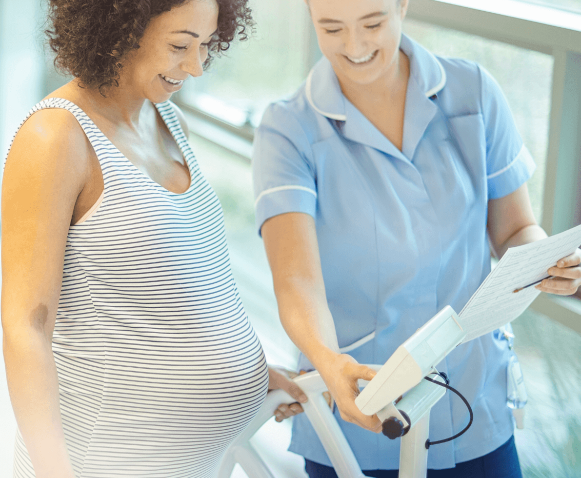 an image of a pregnant woman being shown her ultra sound results by a nurse