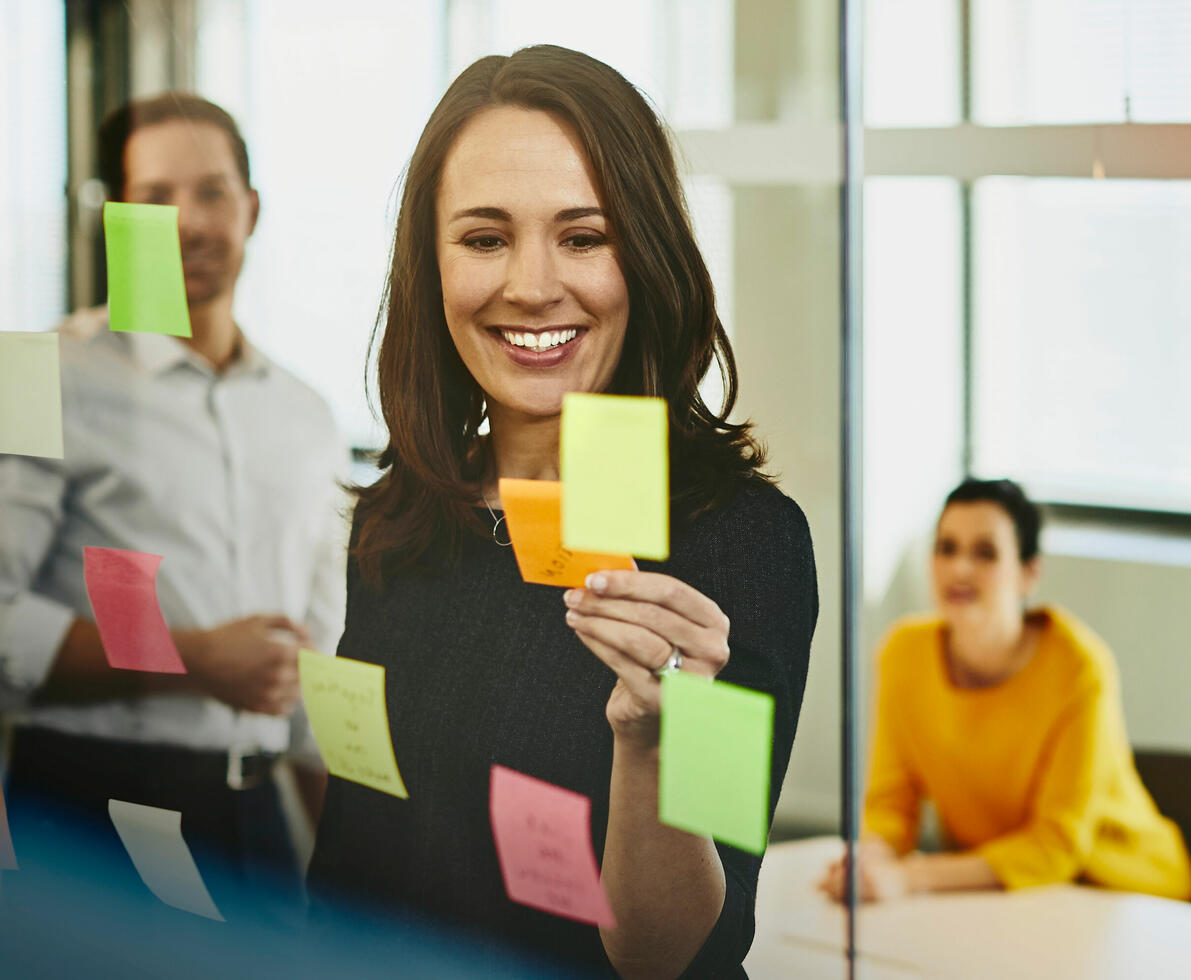 an image of placing sticky notes on the glass walls of the meeting room