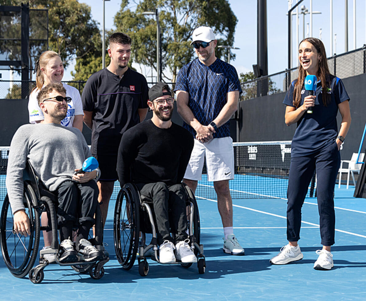 two male tennis players in wheelchairs on a tennis court