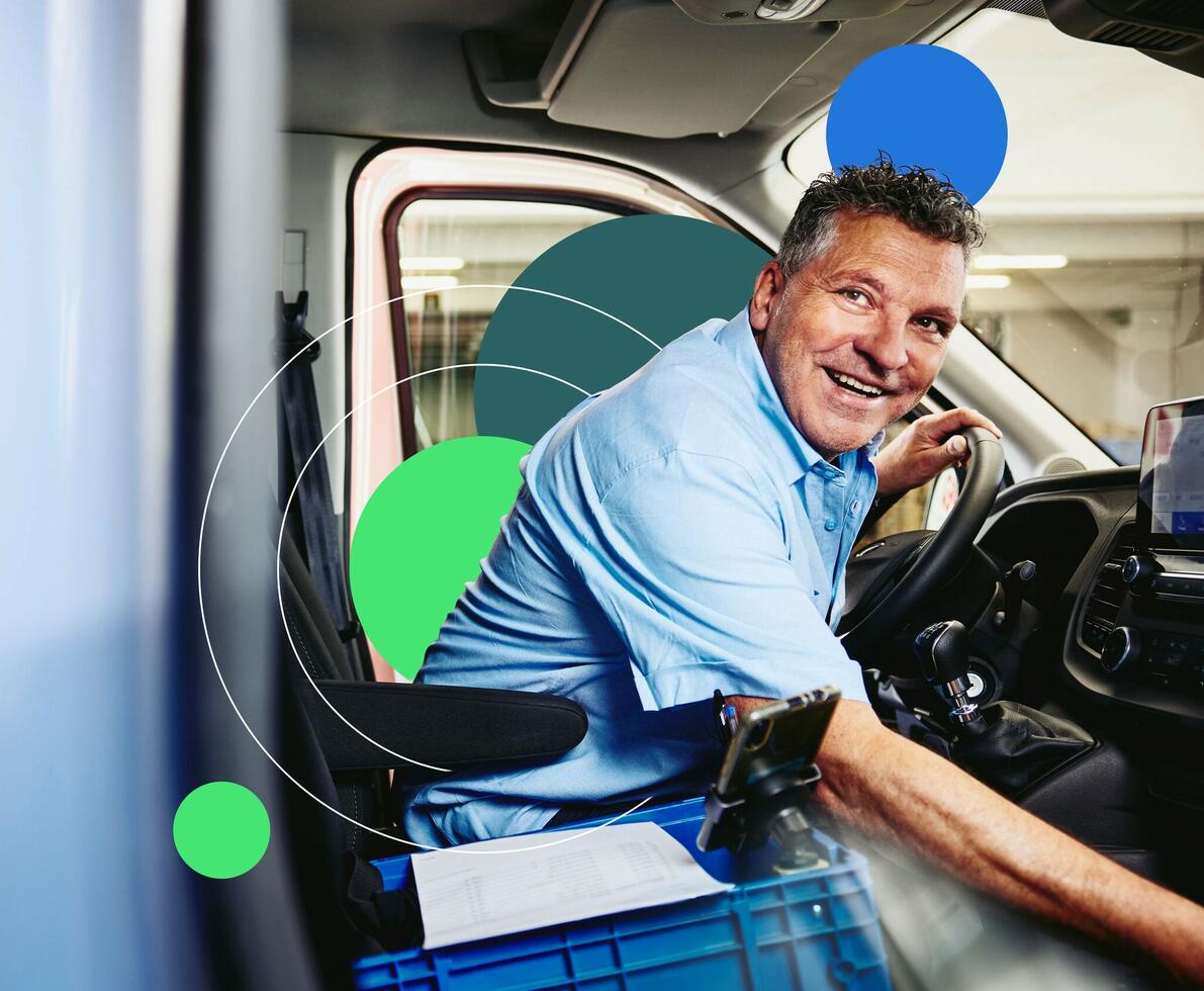 an image of a smiling man sitting in driver's seat of a logistics truck