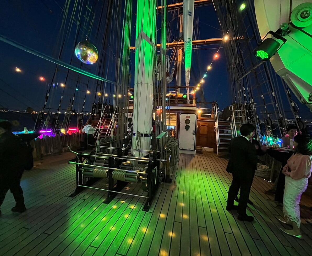 clipper boat with people on it, having a great time with disco lights