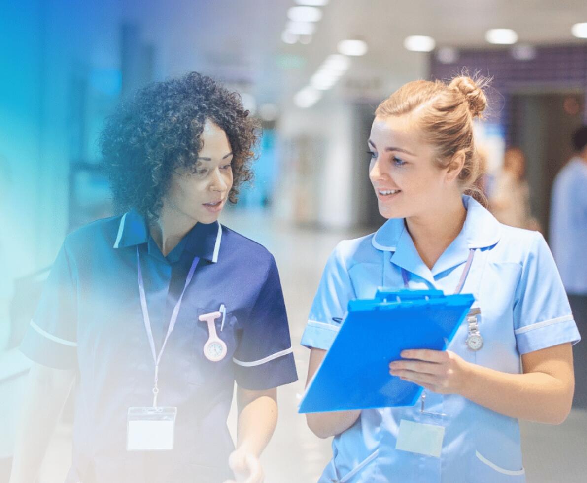two nurses talking and smiling at each other