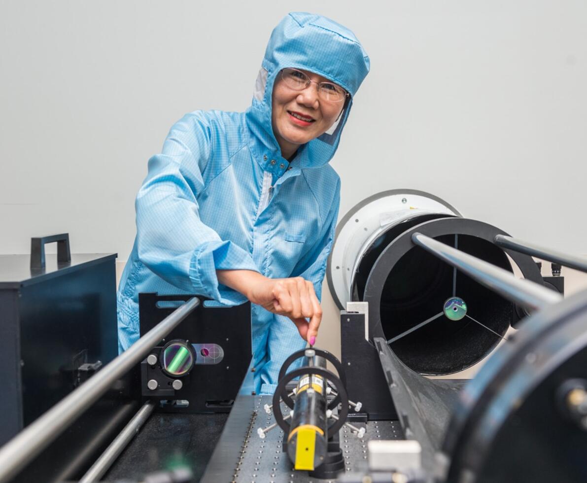 an image of a woman wearing a protective suit smiling 