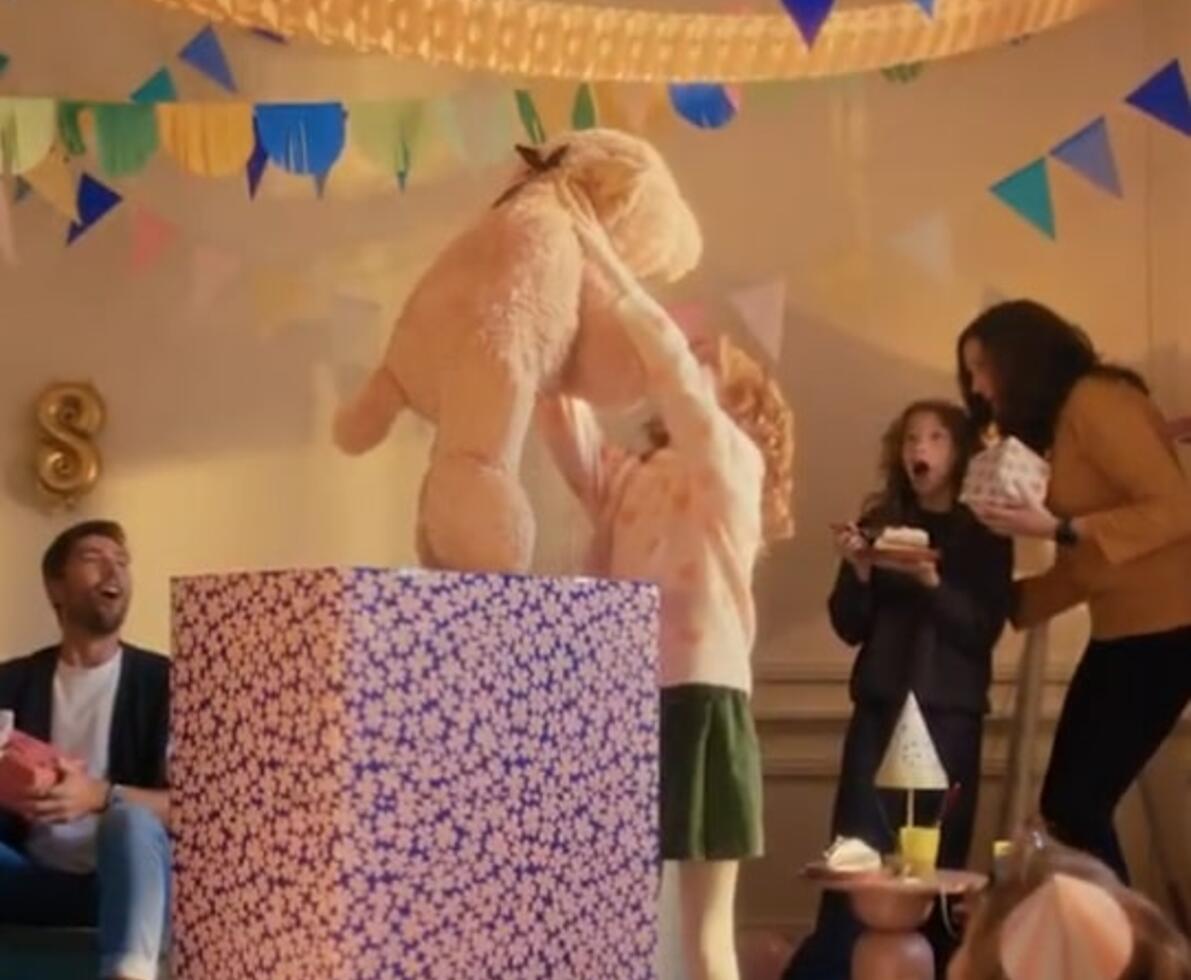 an image of a kid lifting a teddy bear