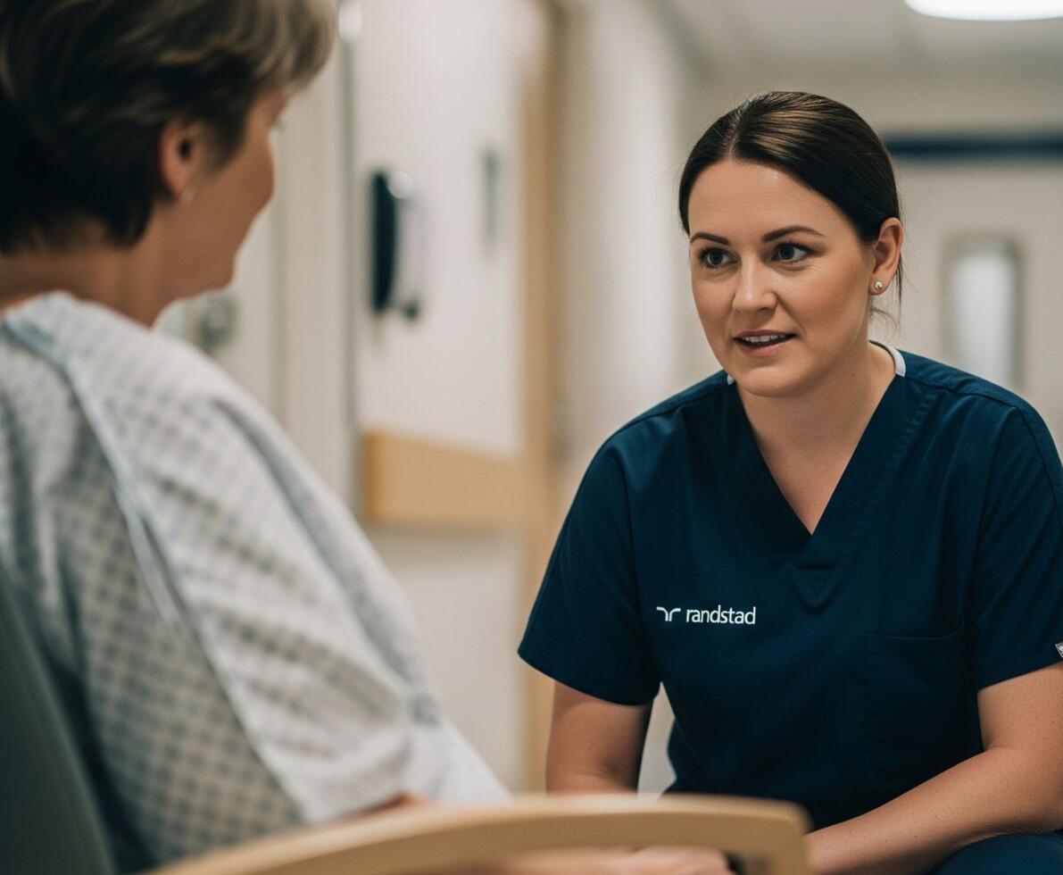 image of a nurse in scrubs talking to a patient that is seated image of a nurse in scrubs talking to a patient that is seated