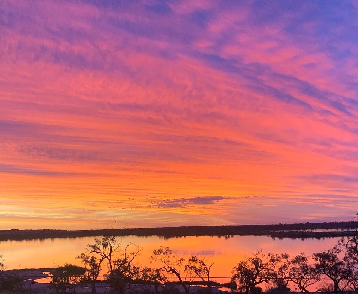 an image of a body of water with an orange sky