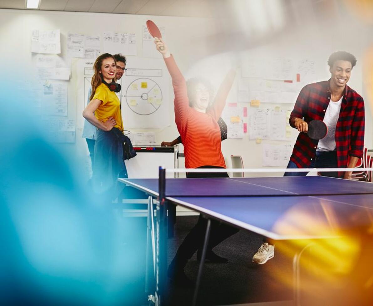 A group of people enjoying a game of table tennis