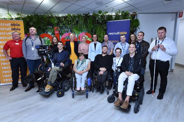 group of people sitting and standing smiling for the photo 