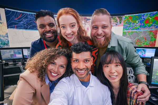 an image of a group six coworkers smiling brightly