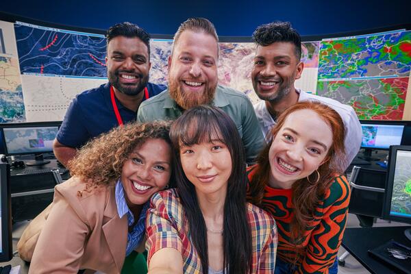 an image of a group six coworkers smiling brightly
