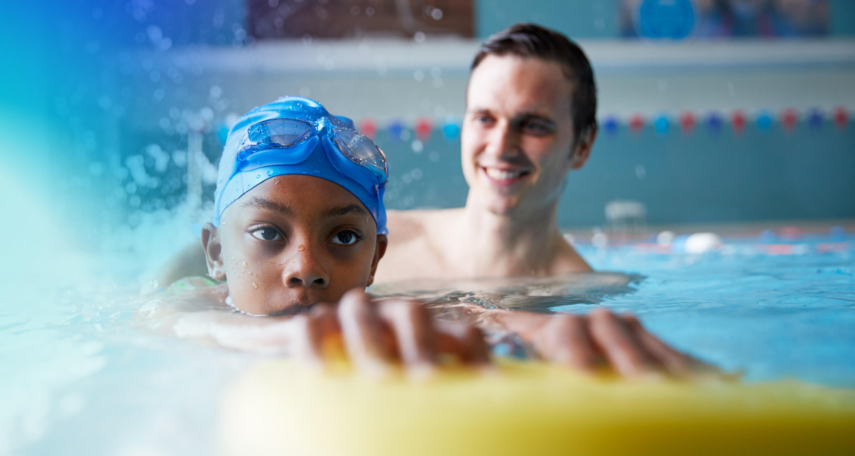 an image of a man teaching a kid how to swim 