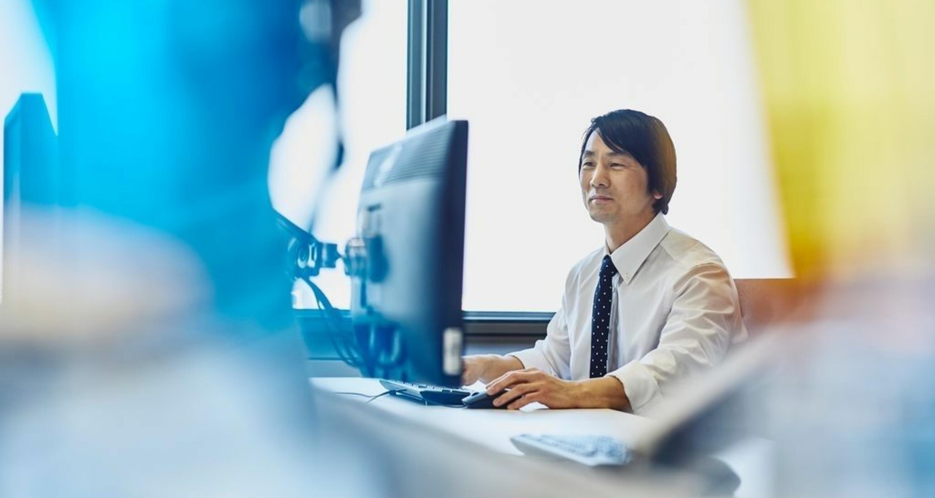 Man in his suit working on his desktop
