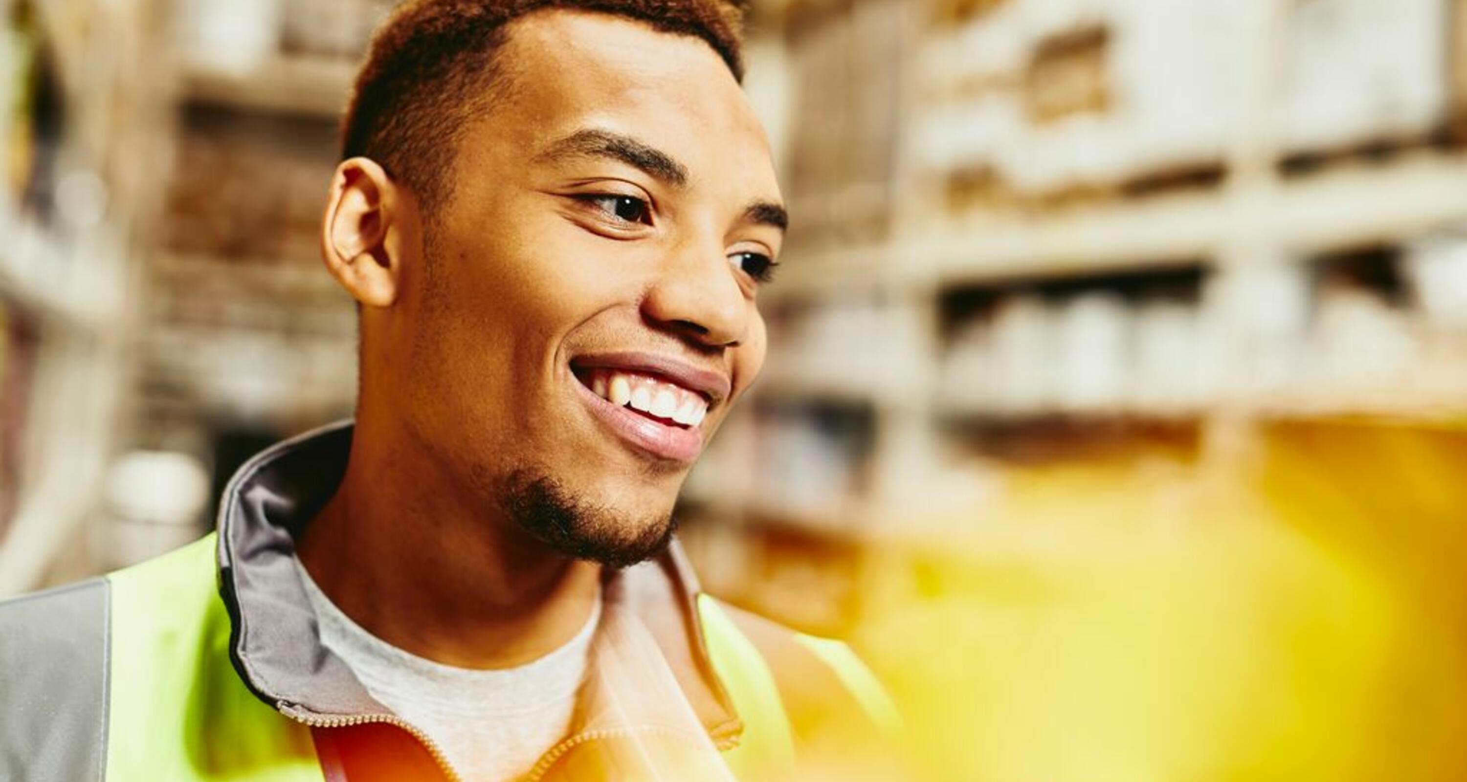 A photo of a man working as a forklift driver