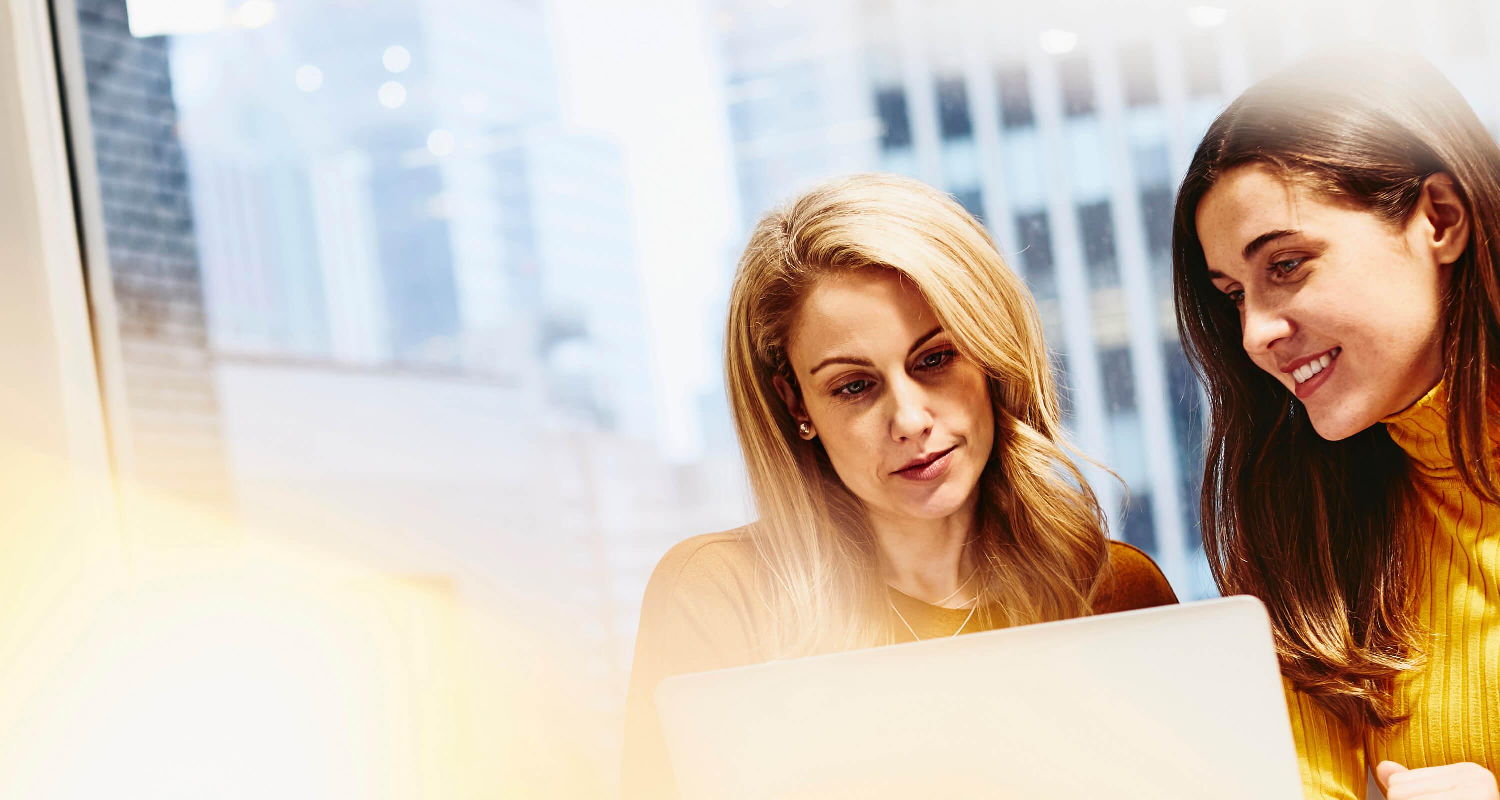A photo of two women working together 