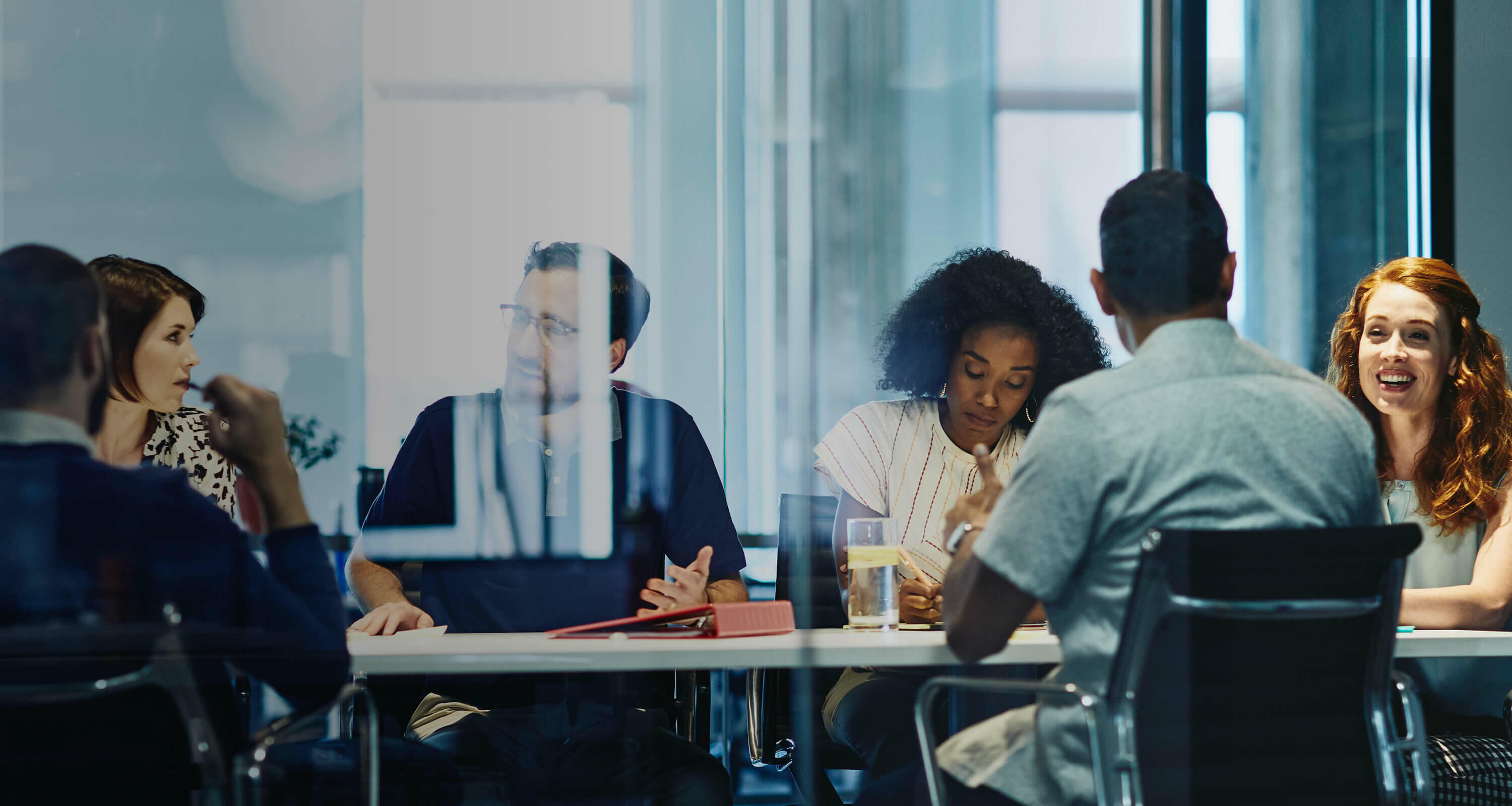 people working in an office boardroom