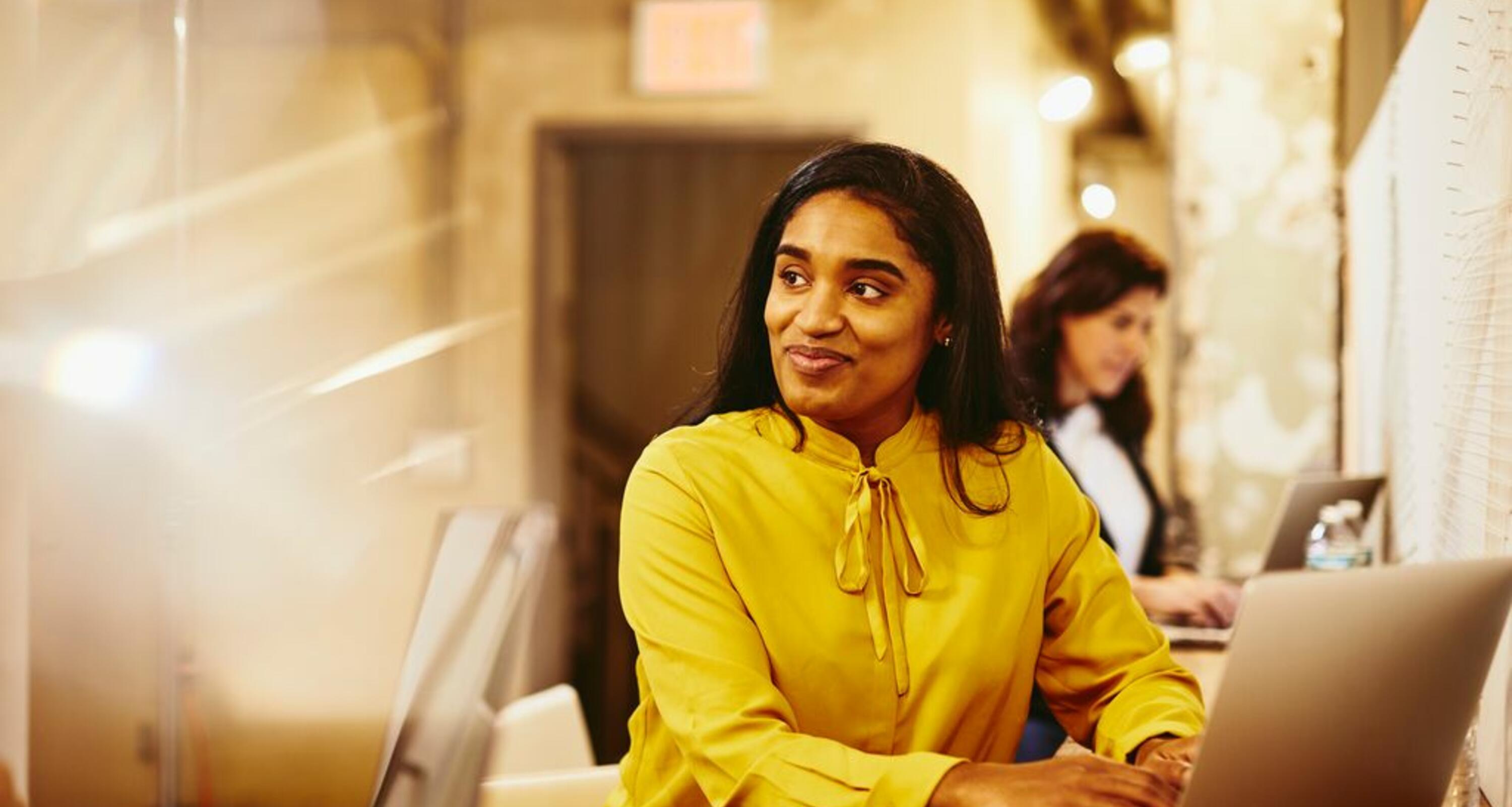 A photo of a woman smiling while looking to the left