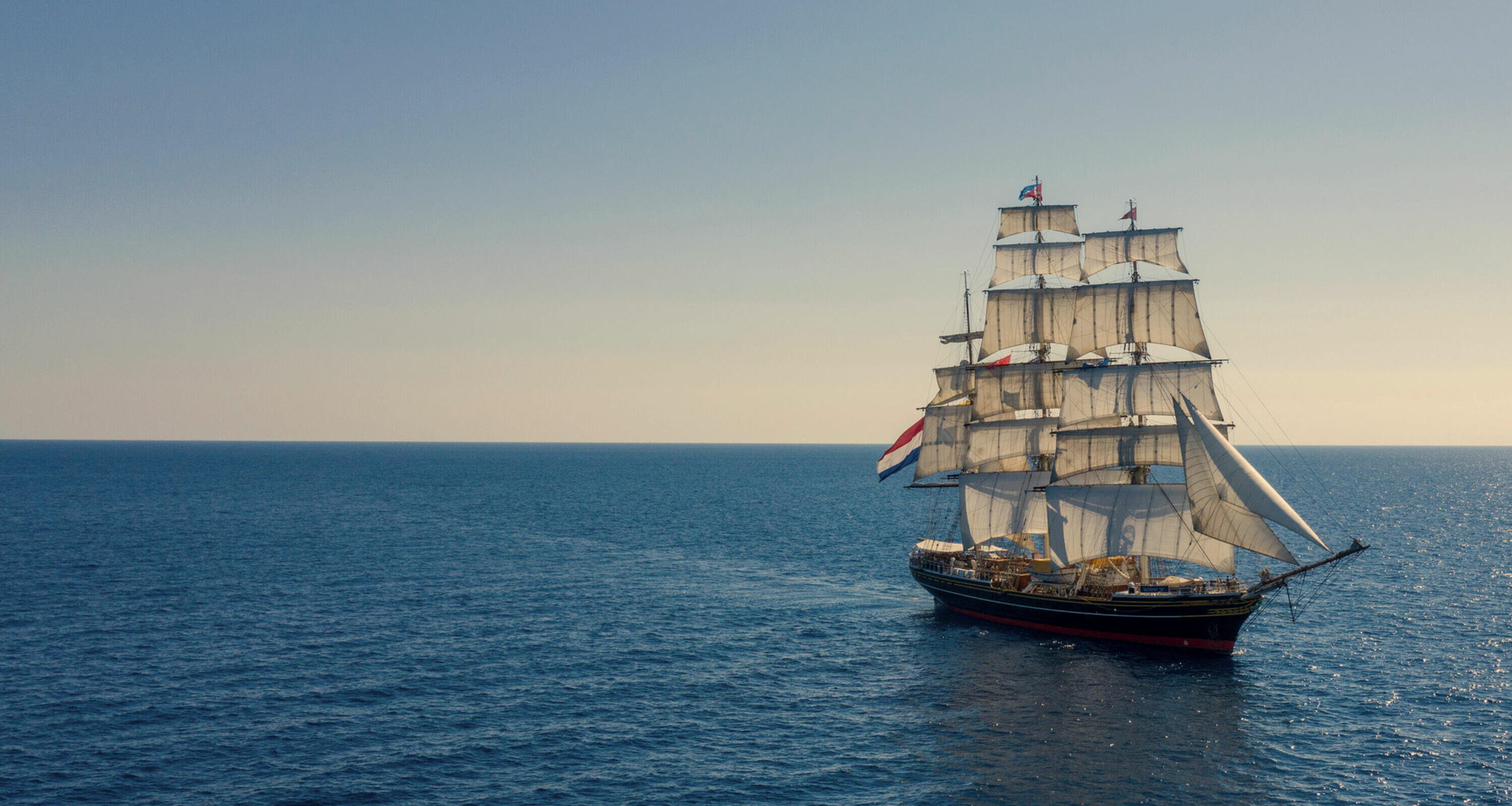 randstad clipper sailing on sea into the sunset