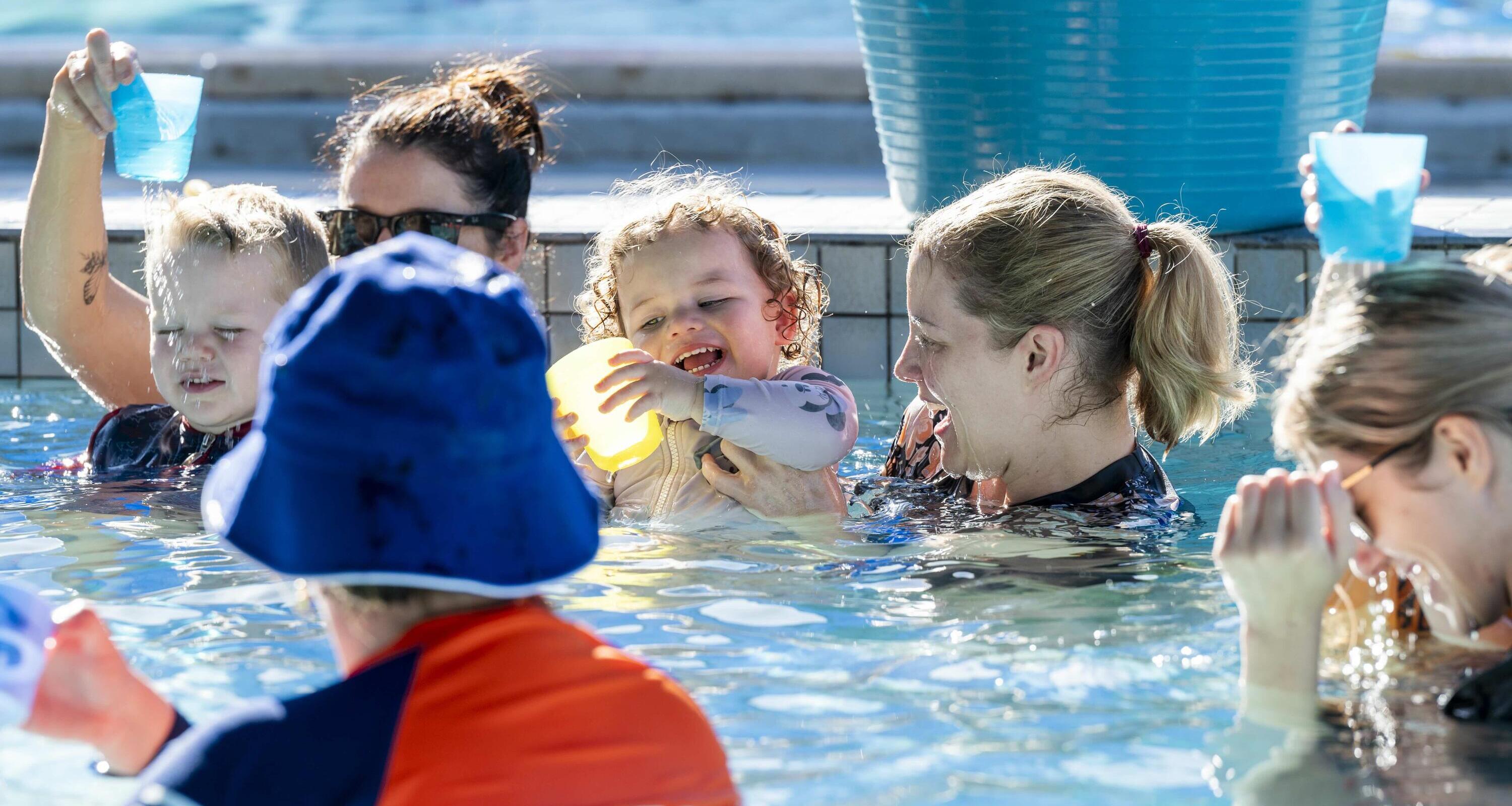 swim instructor in pool with class 