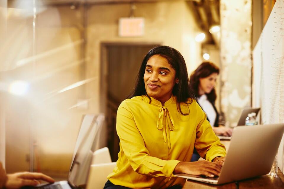 A photo of a woman smiling while looking to the left