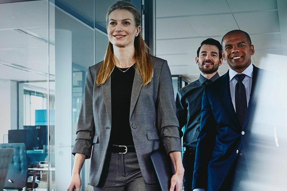group of 3 people walking through an office
