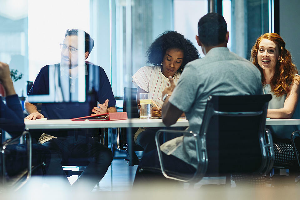an image of a group of people inside a meeting room 