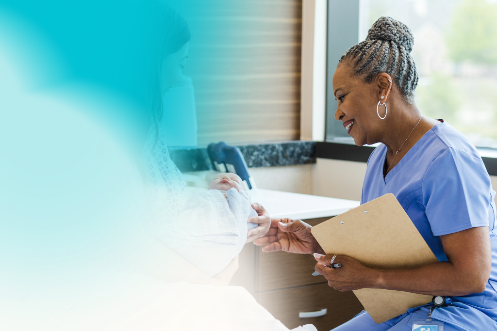healthcare professional smiling while looking at a baby