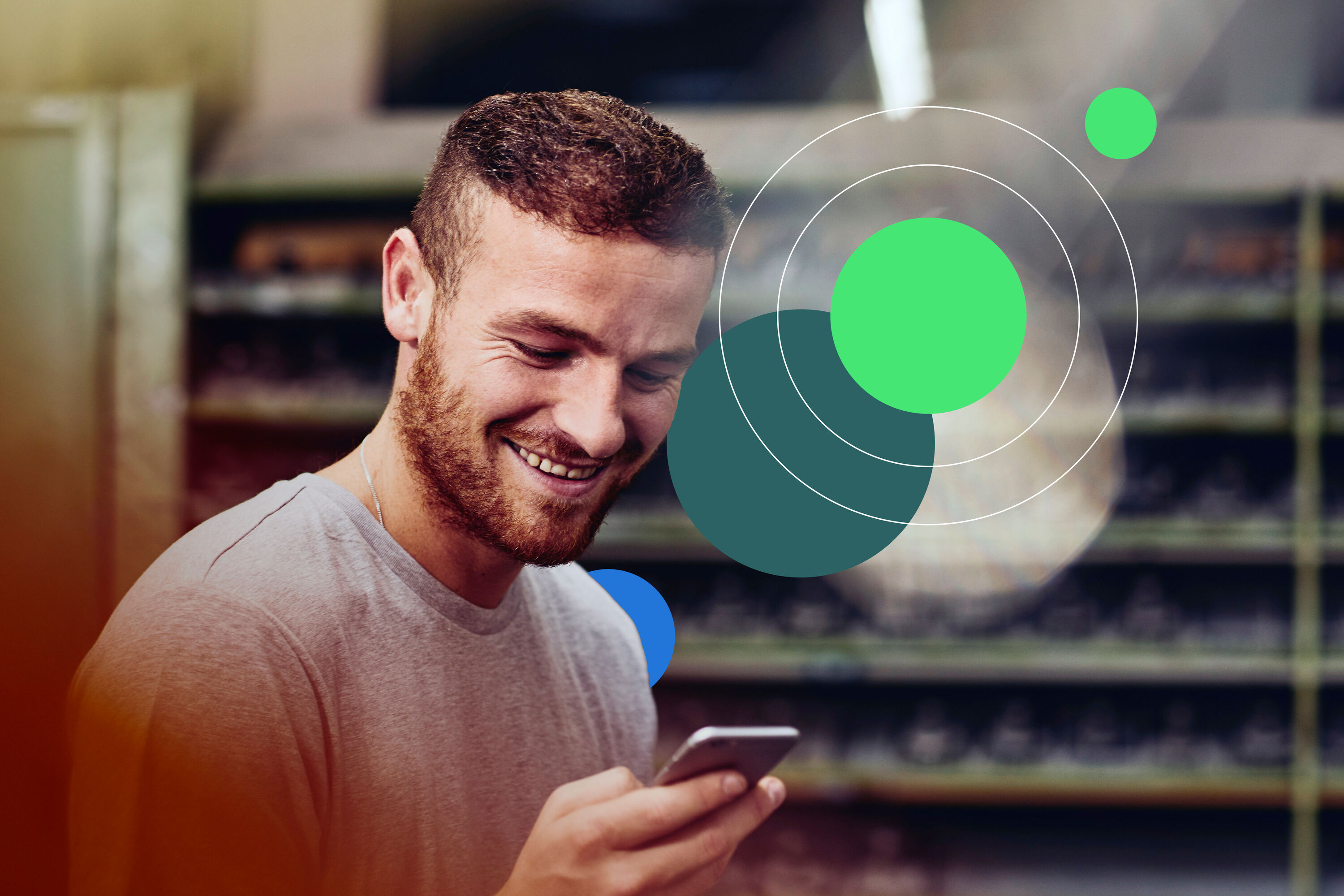man smiling looking at phone