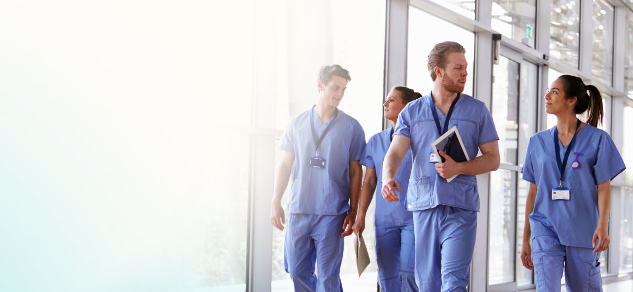 healthcare workers walking through a healthcare facility having a conversation