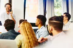 an image of a teacher explaining something to his students