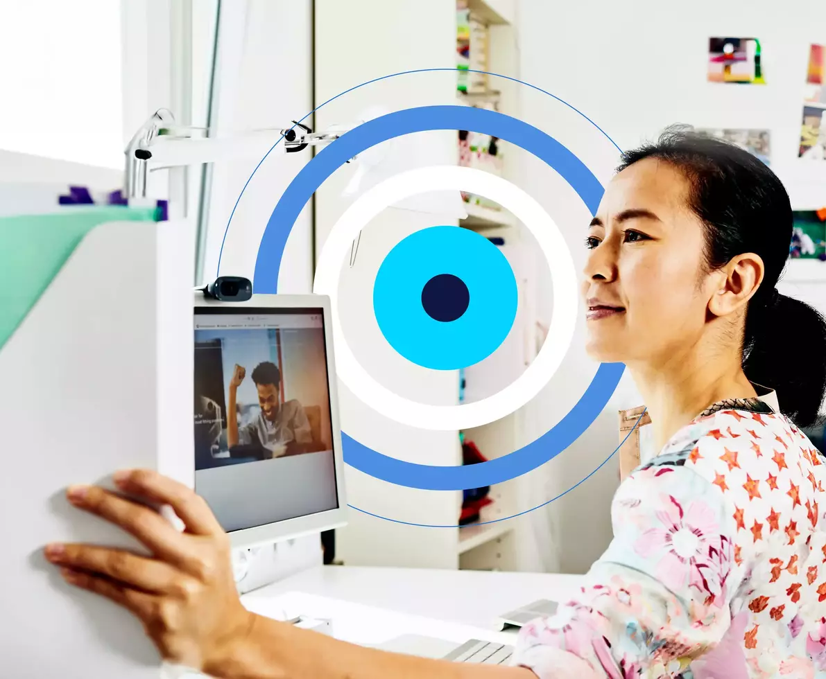 woman getting a folder sitting at her desk with a blue, cyan and white circular illustration in the background