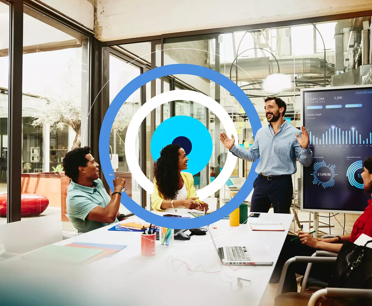 man presenting work to his colleagues in a conference room with a tech circular motion in blue, white and cyan 