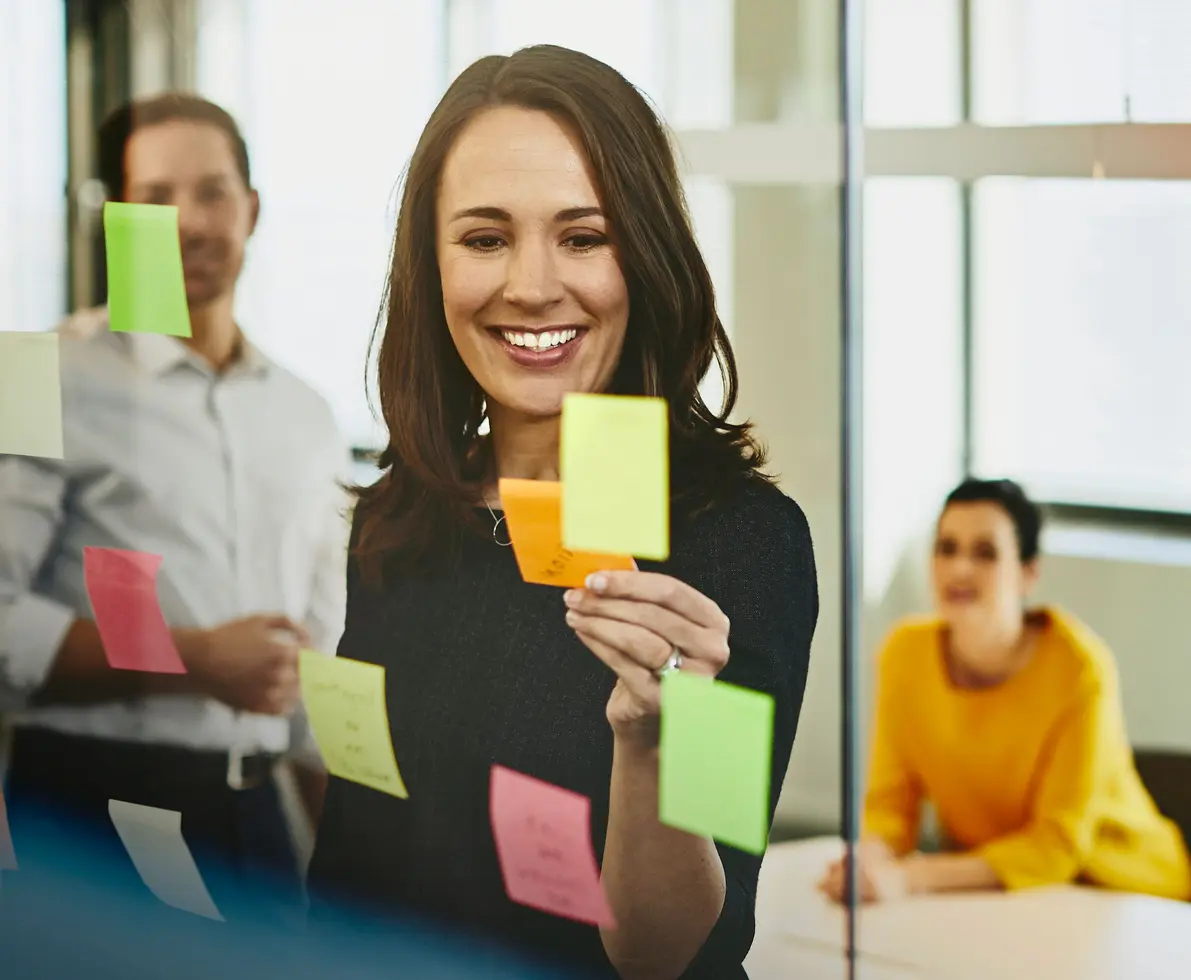 an image of placing sticky notes on the glass walls of the meeting room